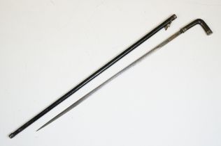 An antique sword stick with horn handle and white metal collars.