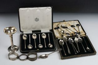 A collection of sterling silver to include a bud vases, napkin rings, cased tea and coffee