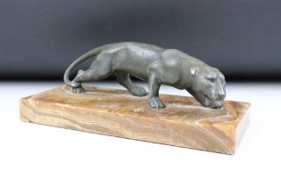 20th Century cast metal figurine depicting a prowling panther mounted to a banded stone base.