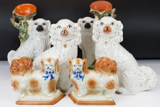 Three pairs of Staffordshire ceramic dog figures, to include a pair of vases with gilt details (