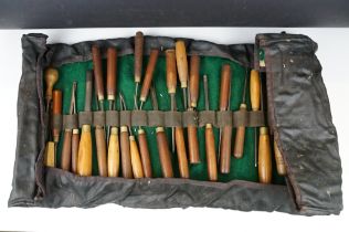 Collection of 39 vintage woodworking chisels, wooden handled, contained within a roll-up case