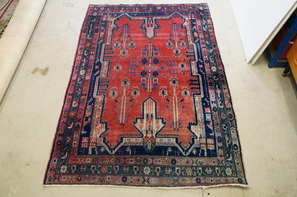 Persian Wool Rug, the red ground with a geometric pattern within a border, 238cm x 160cm