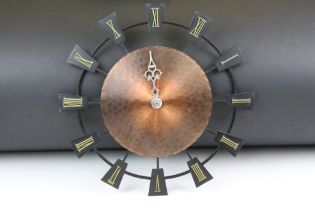 Planished copper & iron battery-operated wall clock with applied brass Roman numerals, approx 37.5cm