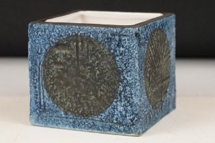 Troika Pottery cube vase with black circular decoration to each face, on a textured blue ground,