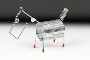 A mid 20th century Japanese chromed spring letter rack in the form of a dog.