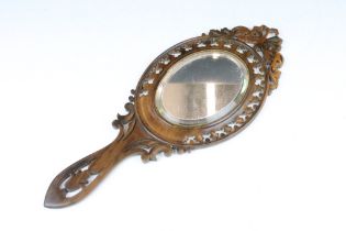 Late 19th Century Victorian walnut Sorrento ware carved wooden hand held mirror having an oval