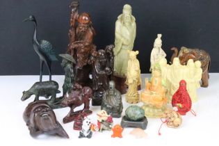 A group of oriental collectables to include carved ornamental fugures, snuff bottle and cast metal