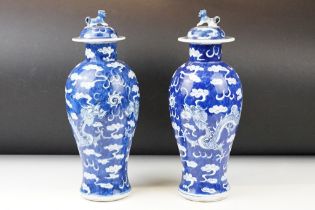 Pair of Chinese blue & white baluster vases and covers, decorated with dragons chasing a flaming