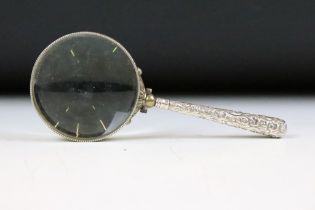 Late 19th / early 20th century magnifying glass, the white metal handle with scrolling Acanthus leaf