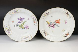 Two 18th Century Meissen deep circular dishes with central floral sprays, the moulded borders with