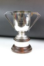 A fully hallmarked sterling silver trophy, maker marked for Walker & Hall with a Sheffield assay