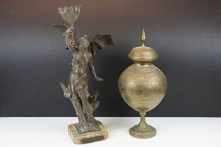 Bronze lamp base in the form of a lady with batwings holding a torch aloft, raised on a marble