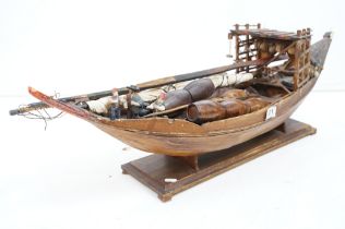 Early 20th century scratch built wooden model of a Portuguese cargo boat, with painted sailor