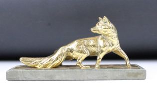 Cast bronze figurine in the form of a prowling fox raised on stone base. Measures 26cm wide.