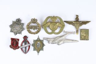 A small collection of military badges to include enamel examples