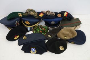 Collection of 20 military caps and berets with associated badges to include Serbia Air Force,