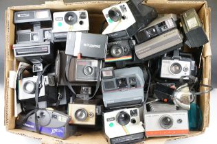 A large collection of Polaroid Instant cameras to include a Polaroid 600, Impulse and various SX-