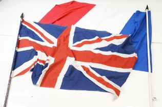 Two large flags on poles to include a vintage Union Jack cloth flag and a French tricolour