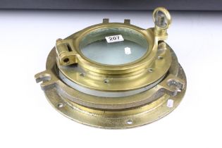 Two brass portholes, the largest cover stamped John Roby Ltd (with matched base plate, approx 33cm