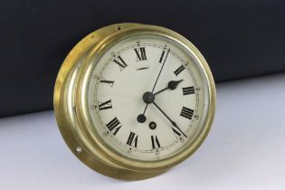 Mid 20th century brass cased ships clock, the cream dial with Roman numerals and poke-style hands,