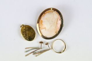 A small collection of yellow metal jewellery to include ring, earrings, locket and cameo brooch.