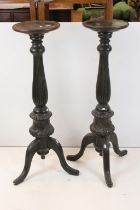Pair of 19th century Ebonised Jardiniere Stands, each with round tops over carved column supports