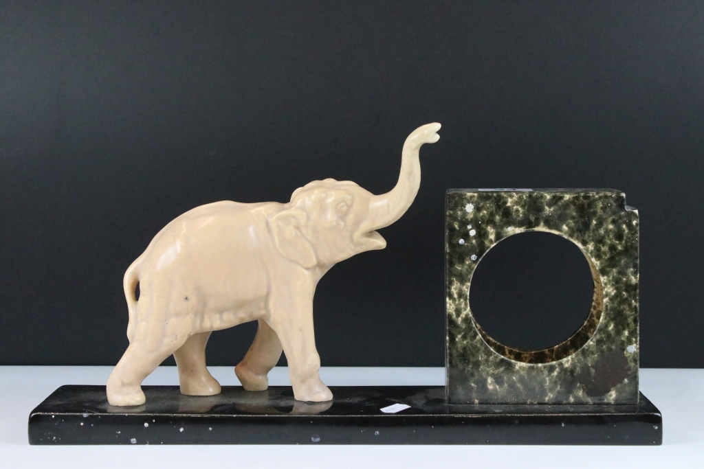 Art Deco Ceramic Clock Holder, the slate base surmounted by an Elephant, 44cm long x 22cm high