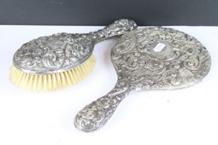 A fully hallmarked sterling silver brush together with a similar hand mirror.