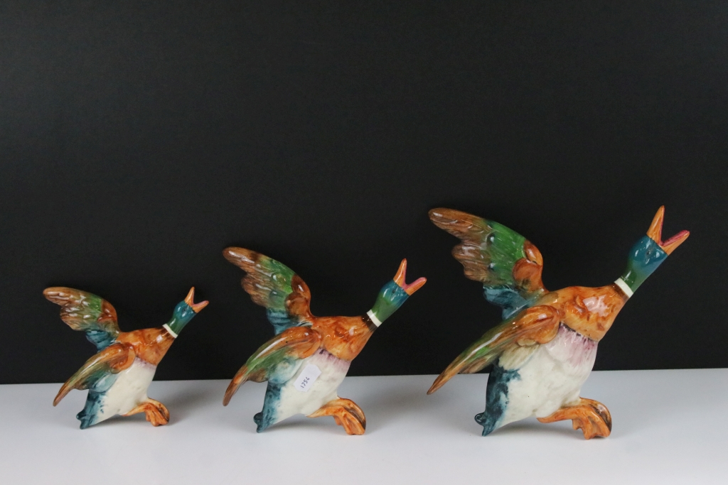 Set of three Beswick ceramic flying duck wall plaques, each having hand painted details. Marked