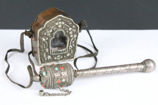 A white metal Tibetan prayer wheel set with red and blue cabochons together with an amulet.