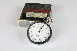 A vintage Heuer stopwatch complete with original box and instruction booklet.