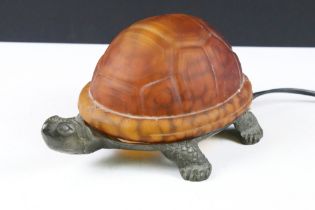 Novelty table lamp modelled as a tortoise, with cast metal body and a mottled orange glass shell.