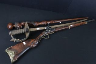 Reproduction non firing French flint lock musket together with a reproduction sword and carved