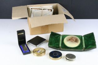 A box of mixed collectables to include pocket cigarette lighters, powder compacts, postcards....etc.