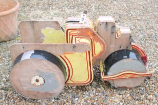 Mid 20th C steam roller fairground ride with pin striped detail, approx 104cm long (a/f)