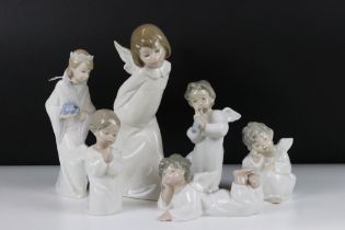Six Lladro figurines to include five figure with angel wings and one wearing a crown. Tallest