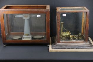 Pair of Avery factory scales set within a wooden and glass case, together with a brass Stephenson'