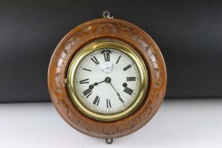 Carved wood & brass nautical ships clock, the white enamel dial with Roman numerals, poker style