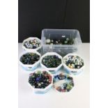 A large collection of mixed glass marbles contained within six boxes.