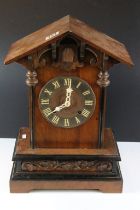 Late 19th / early 20th century Black Forest carved oak mantle cuckoo clock, the circular dial with