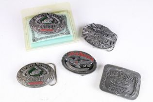 A collection of five pewter belt buckles to include Jack Daniels examples.