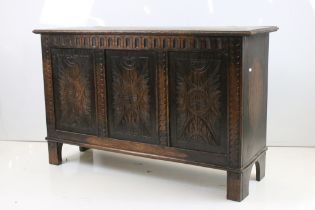 Oak Coffer in the 17th century style with hinged lift lid and three carved panels to front, raised