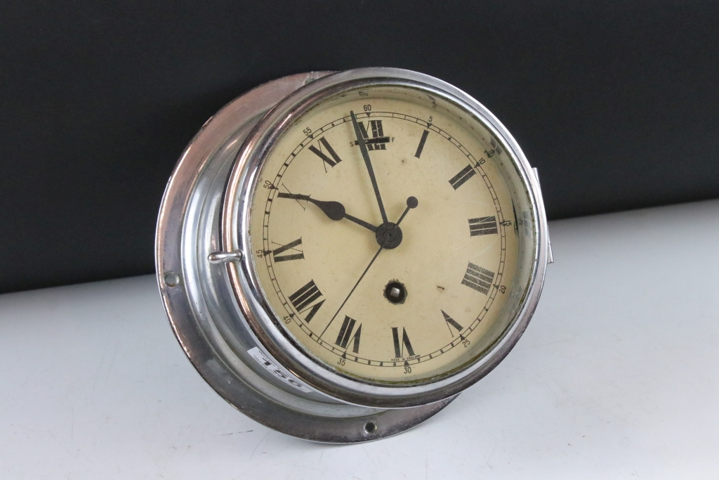 Chrome bulkhead nautical ships clock, the cream dial with black Roman numerals and poker style