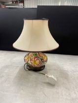 Moorcroft ceramic lamp base in the frangipani pattern having tube lined yellow and pink flowers.
