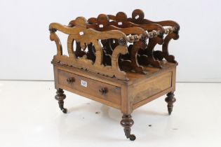 Victorian Rosewood Canterbury having four carved pierced scrolling sections over a drawer, raised on