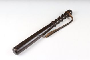 Early 20th century turned wooden truncheon, with ribbed grip and leather strap, approx 38cm long