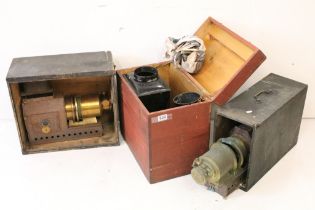 A collection of three magic lantern projectors contained within storage cases to include a 'The