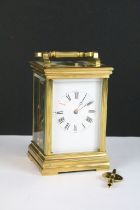 A brass cased carriage clock with bevelled glass panels, with hourly repeater button to the top.