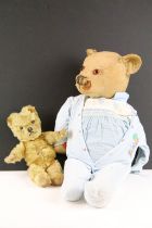 Two early to mid 20th century teddy bears, one being golden mohair and the larger with straw