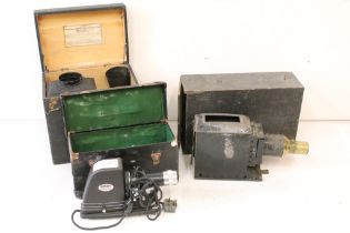 Two magic lantern slide projectors together with a later electric example, all complete with storage
